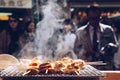 Grilled seafood scallop and sea Ã¢â¬â¹Ã¢â¬â¹urchin eggs skewer with smoke, japanese street food at Tsukiji Fish Market, Japan. selective Royalty Free Stock Photo